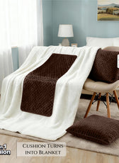 Brown cushion with blanket feature on a sofa in a living room setting
