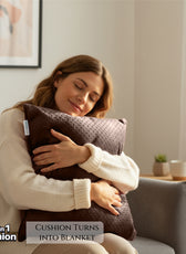 Woman hugging a 2-in-1 cushion that turns into a blanket in a cozy living room.